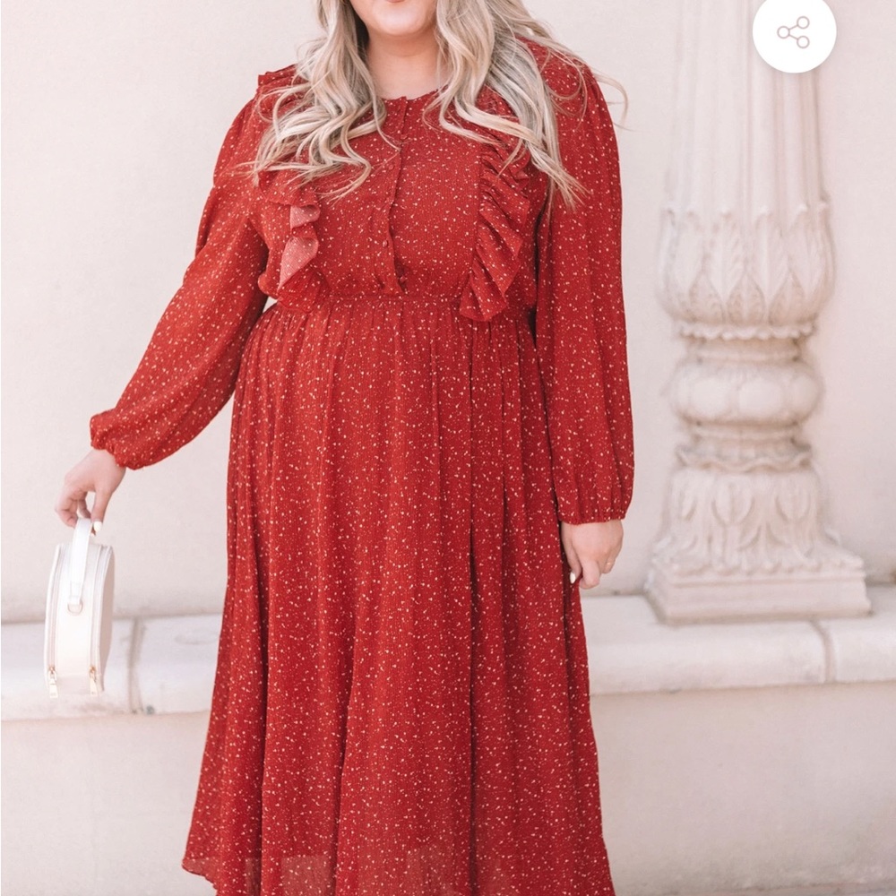 Red speckled dress, floor length, oversized sleeves.